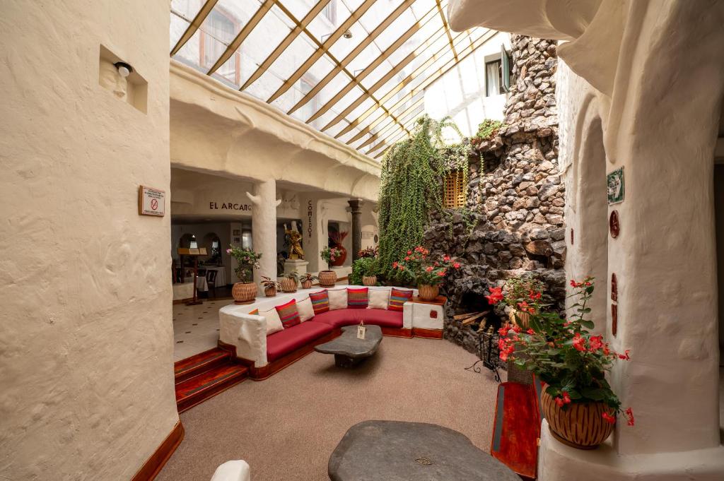 a living room with a couch in a building at San Agustin Internacional in Cusco
