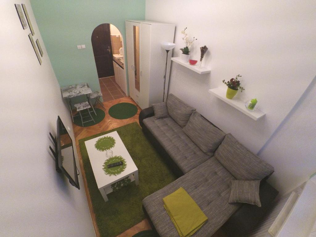a living room with a couch and a table at Sleep and Go Pedja in Belgrade