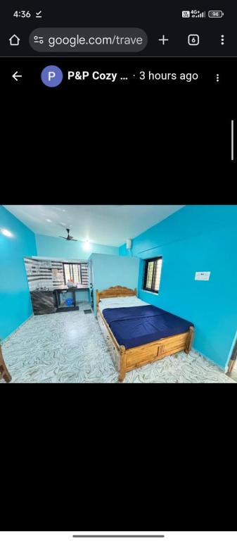 a blue bedroom with a bed in a room at P&P Cozy Corner in Cola