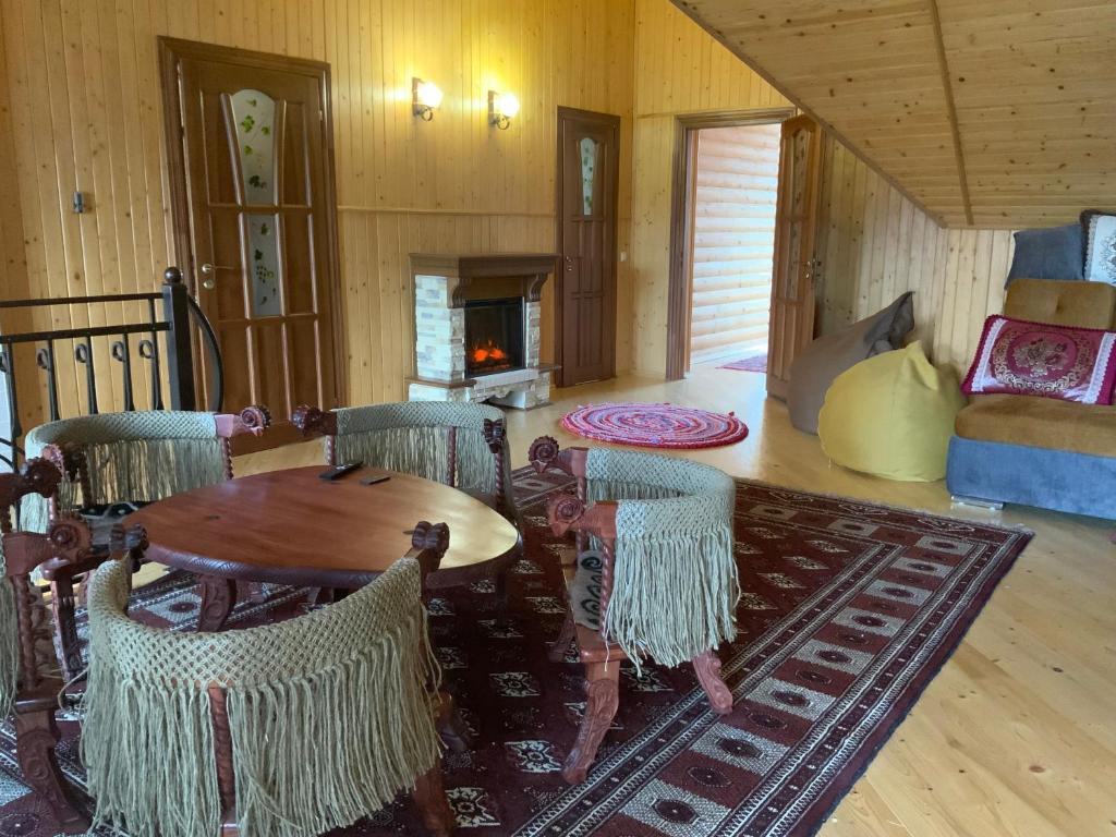 a living room with a wooden table and chairs at Пентхаус РіОНі Трускавець in Truskavets