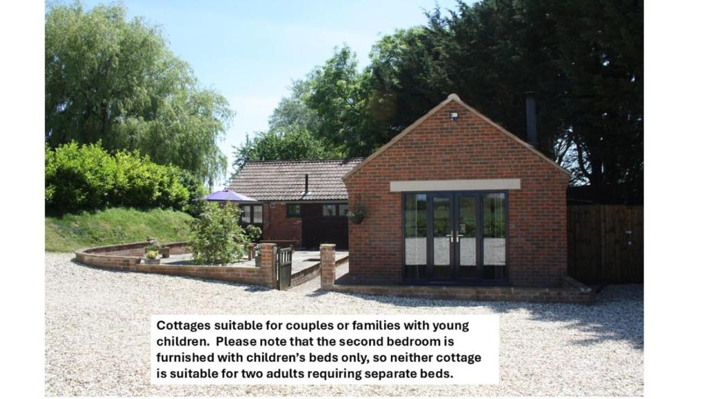 a small brick house with the for couples or families with vows at The Rectory Lacock Cottages in Lacock