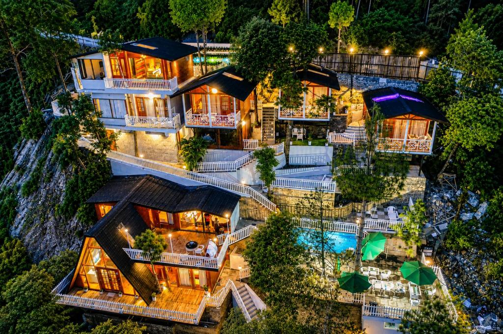 an aerial view of a house with a pool at Koro Treehouse Resort Luxury Jacuzzi Cottages and Jacuzzi Villas in Kasauli