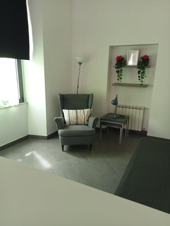 a living room with a chair and a table at Bastioni VALE in Pescara