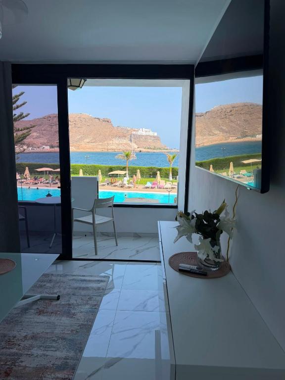 a living room with a view of a pool at Cura Marina 2 in Playa del Cura
