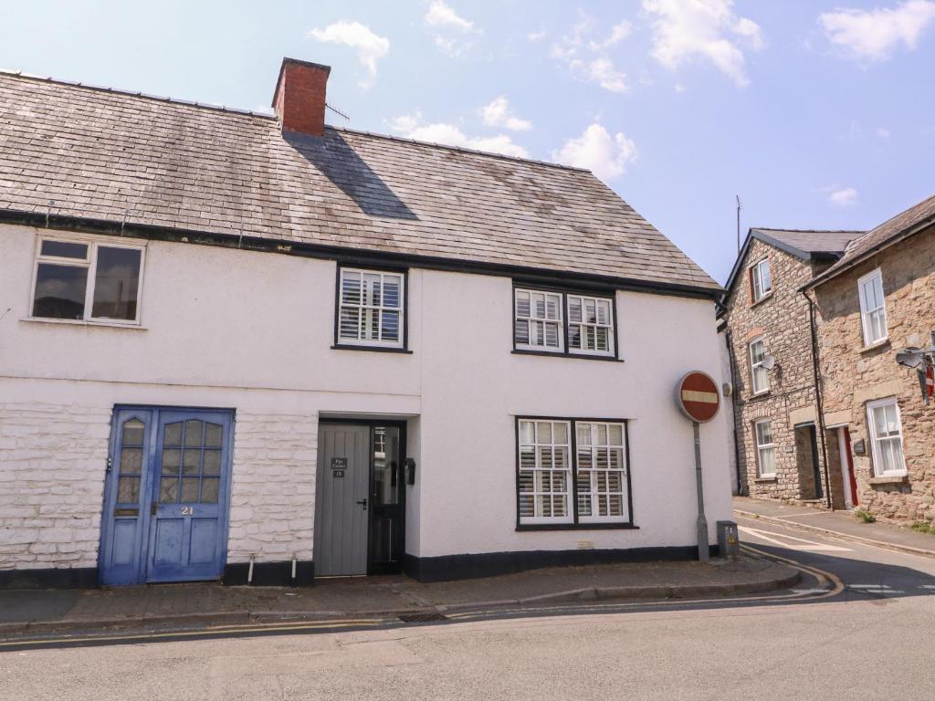 a white house with blue doors on a street at 19 Lion Street in Hereford