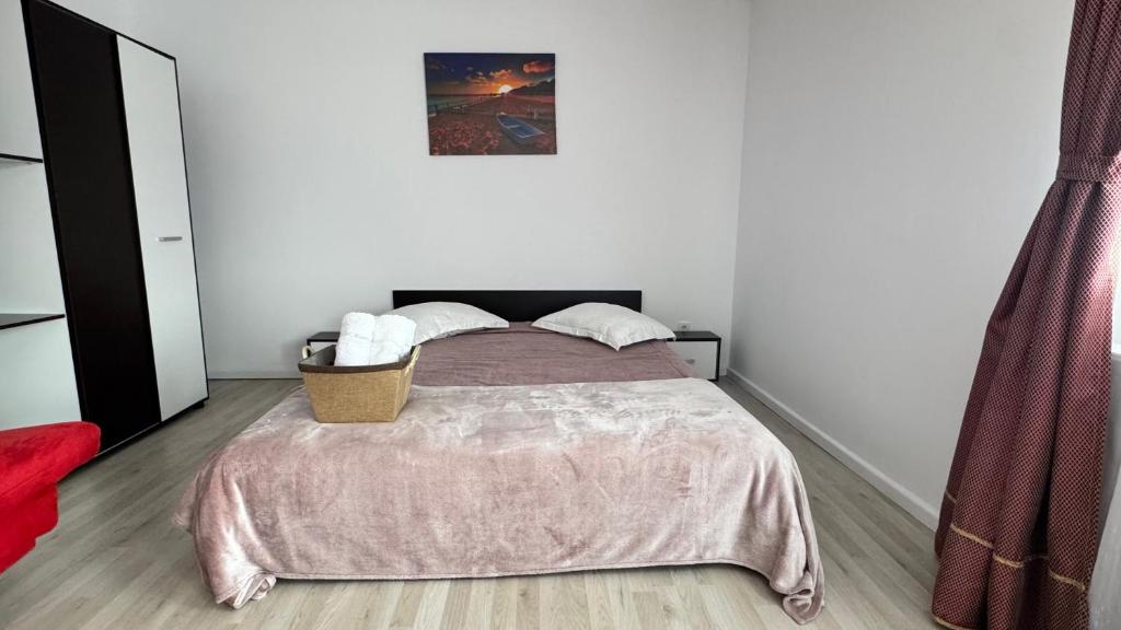 a bedroom with a bed with a blanket on it at Villa Odorica in Gura Humorului