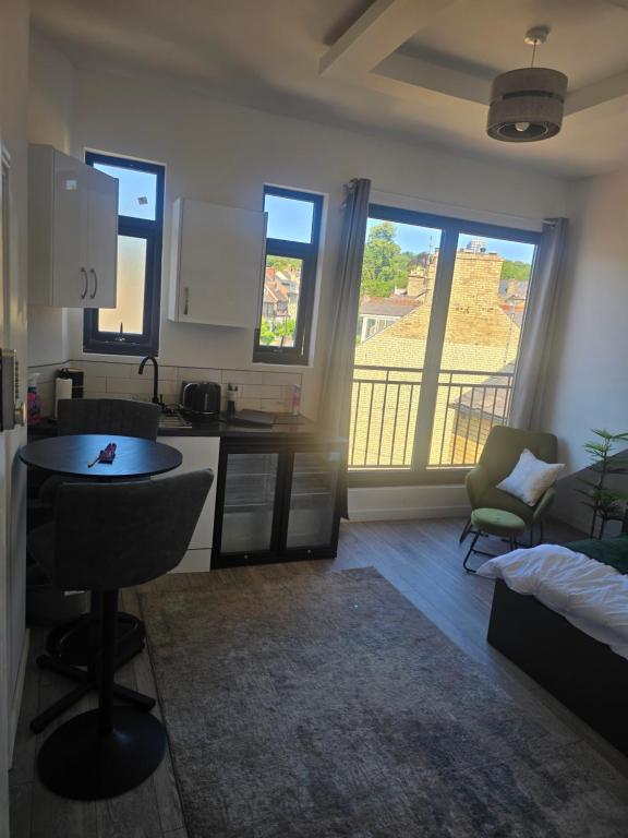 a small kitchen with a table and a balcony at Encliffe apartment in Nether Edge
