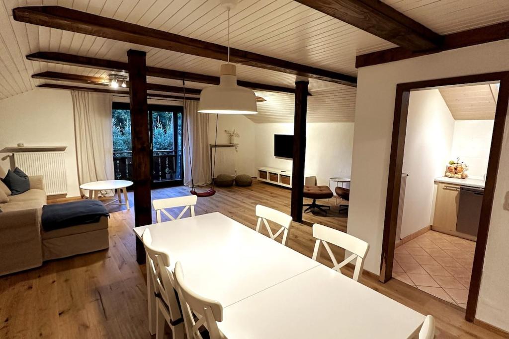 a living room with a white table and chairs at Apartment in the Upper Bavarian Alps in Bad Kohlgrub