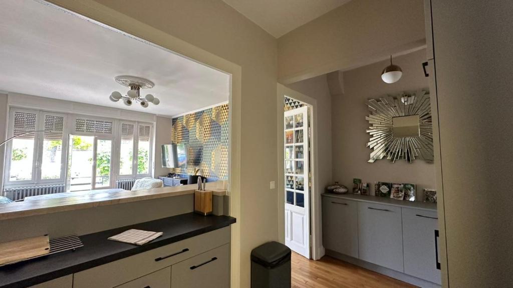 a kitchen with a large sink and a mirror at Maison Diderot in Langres