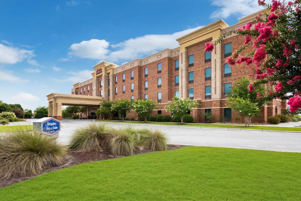 a large brick building with a sign in front of it at Hampton Inn and Suites Swansboro Near Camp Lejeune in Swansboro