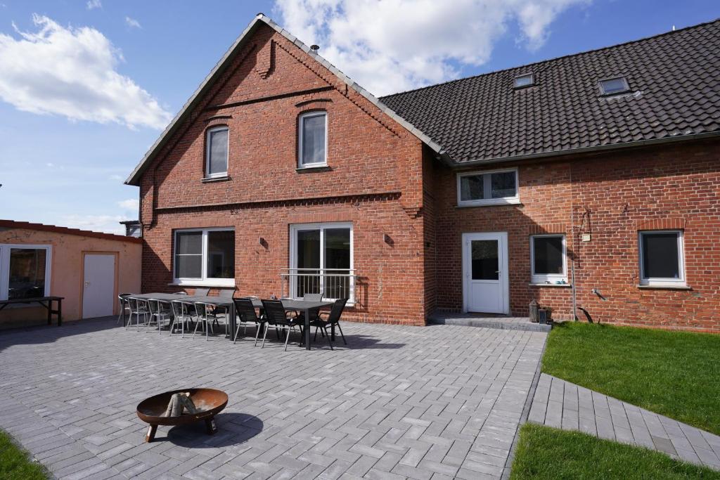 a brick building with a patio with tables and chairs at Ferienhaus Weserblick in Rinteln