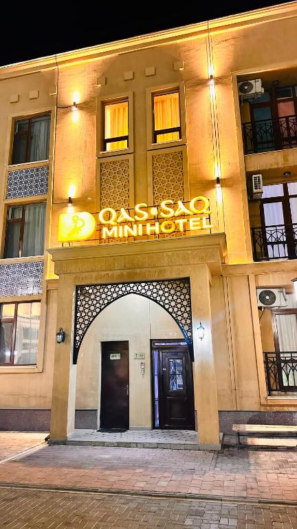 a building with a sign on the front of it at Qas-saQ in Türkistan