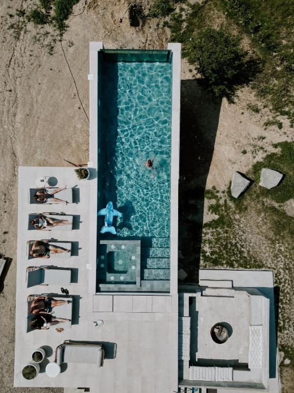 an overhead view of a swimming pool with people in it at Hilltop Munteni in Munteni