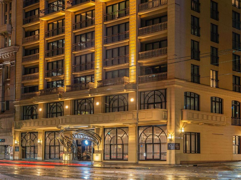 a large building on a city street at night at The Playford Adelaide - MGallery in Adelaide