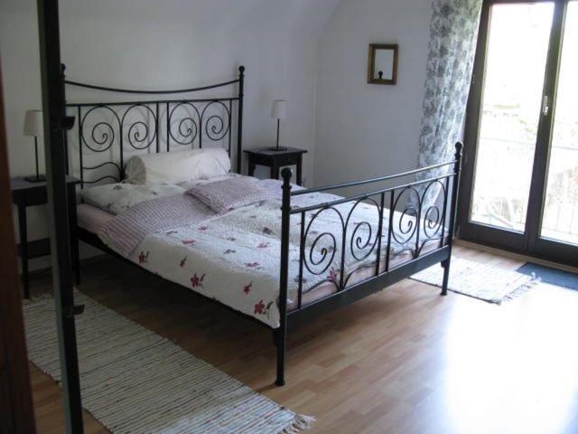 a bedroom with a bed with a wrought iron frame at Haus Rheinsteig in Unkel