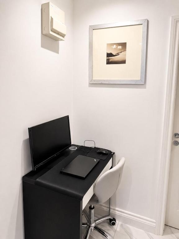 a black desk with a white chair in a room at Studio 38 in Leicester