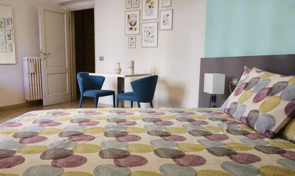 a bedroom with a bed and a table and chairs at Bianca B&B in Florence