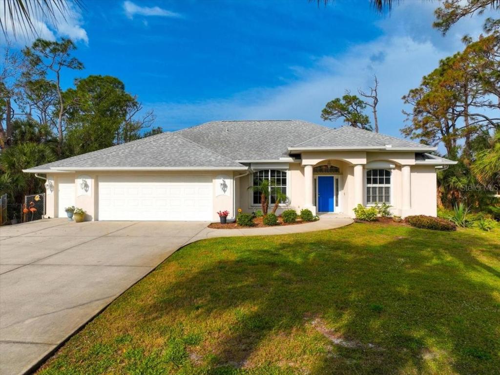 a large white house with a driveway at Palm Tree Parasdise in Englewood