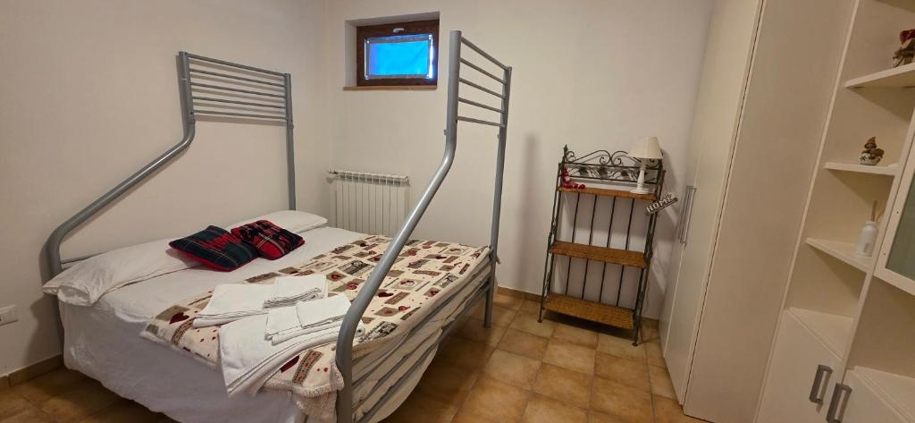 a bedroom with a bed with a metal frame at Marsila in Camigliatello Silano