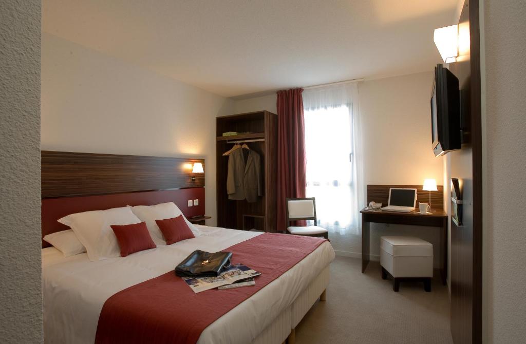 Postel nebo postele na pokoji v ubytování Hôtel Le Palladior Voiron