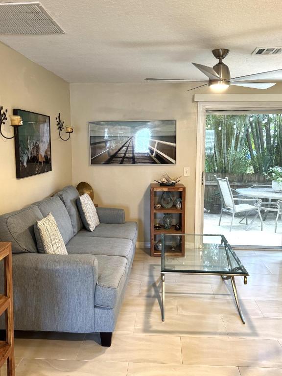 a living room with a couch and a glass table at Coastal Townhome in Jupiter 1 mile to beach! in Jupiter