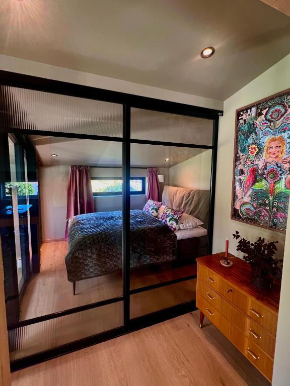 a bedroom with a bed and a large mirror at The Dream Factory in Andøya