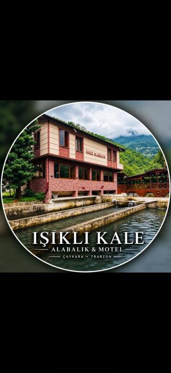 a picture of a building next to a body of water at Isikli Kale Hotel in Çaykara