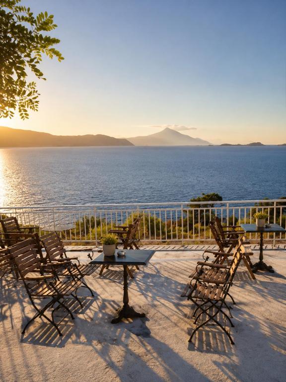 a table and chairs on a patio with a view of the water at Villa Elli in Ammouliani