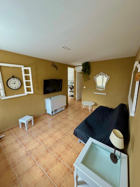 a living room with a couch and a clock on the wall at Casa Pont in Osséja