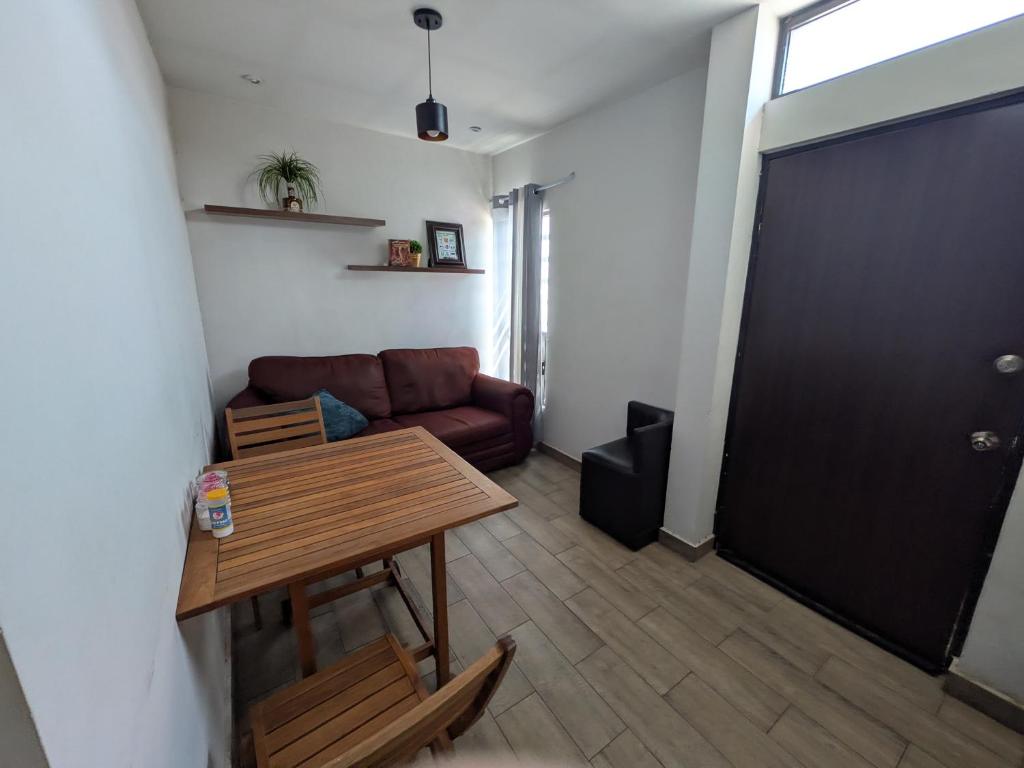 a living room with a table and a couch at Zona nuevo CAMPUS Universidad departamento independiente in Chihuahua
