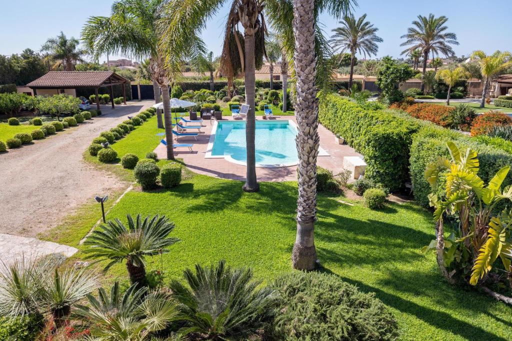 an aerial view of a resort with a swimming pool and palm trees at Villa Tiffany in Marsala