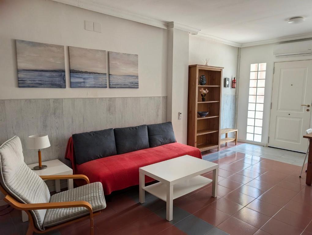 a living room with a red couch and a table at Apartamento Casa Balina in Dúrcal