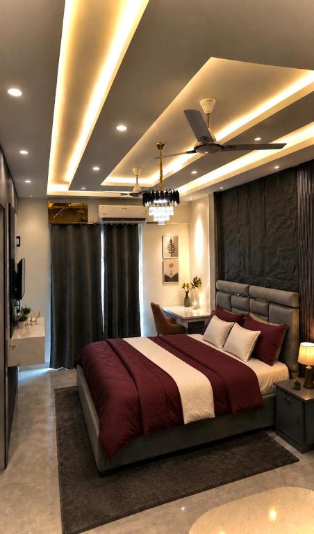 a bedroom with a large bed and a television at Skyline suites in Noida