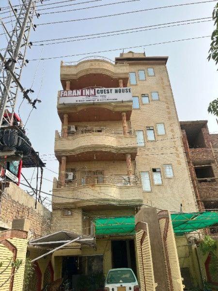 a tall building with a sign on top of it at Faran inn guest house in Hyderabad