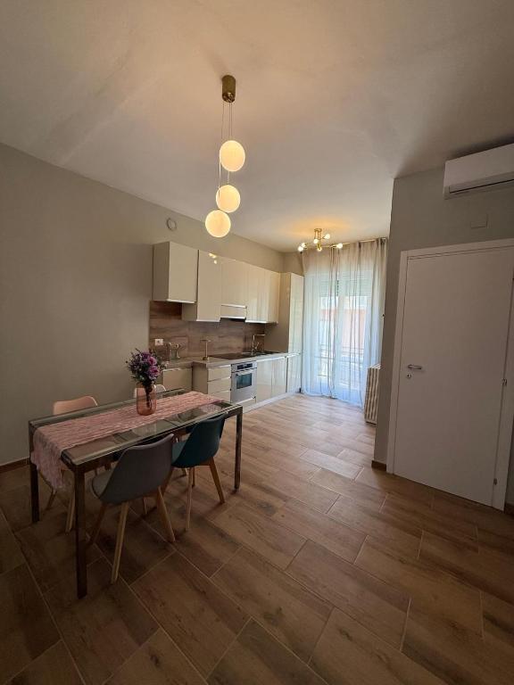 a kitchen and dining room with a table and chairs at Placanica Apartment in Calitri