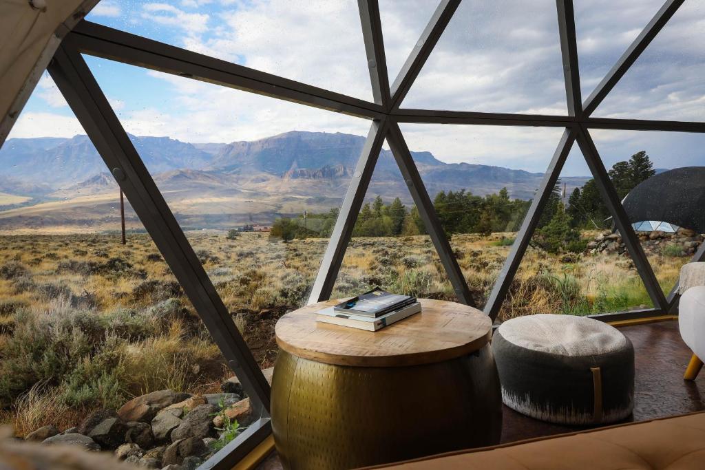 a room with a round table and a window with mountains at Pure Heart Retreat in Cody