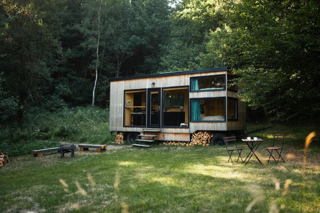 a tiny house sitting in the middle of a field at Včelín Müslivna in Jablonné v Podještědí