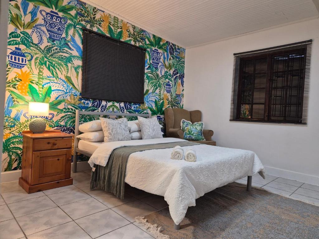 a bedroom with a bed and colorful wallpaper at 52 on 2nd Self-catering accommodation in Gonubie Park