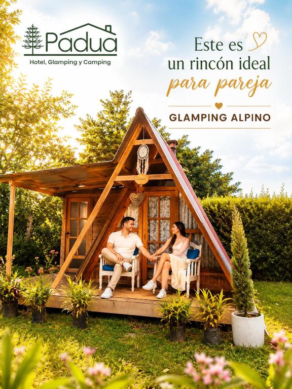 a man and a woman sitting in front of a house at Padua Finca Hotel in Chachagüí