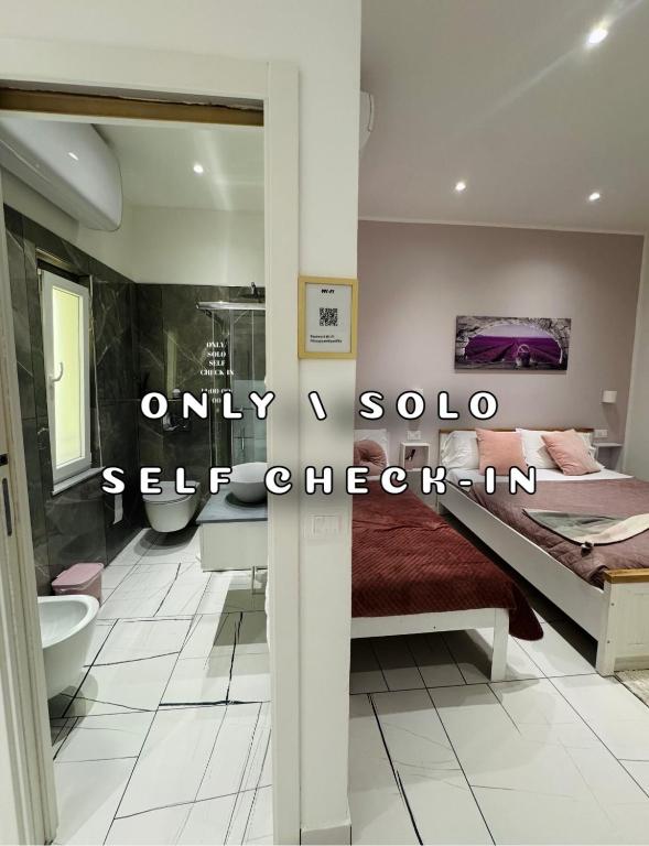 a bedroom with a bed and a sink and a tub at Laura Rooms in La Spezia