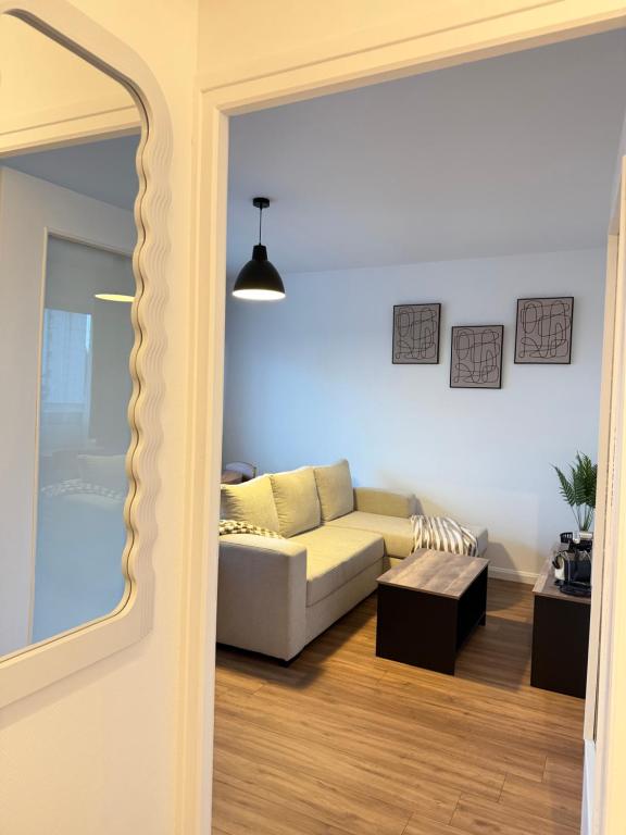 a living room with a couch and a table at Le Cosy in Dunkerque