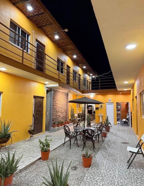 a patio with a table and chairs in a building at Hotel Santa Cecilia in Villa Corona