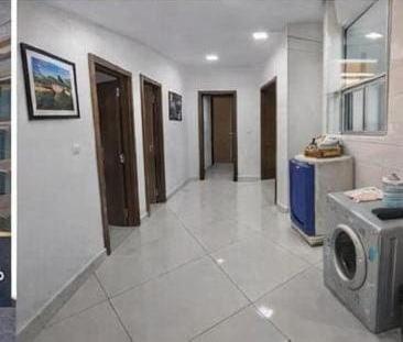 a large room with a hallway with a tv at ApartHotel Amirah in Maputo