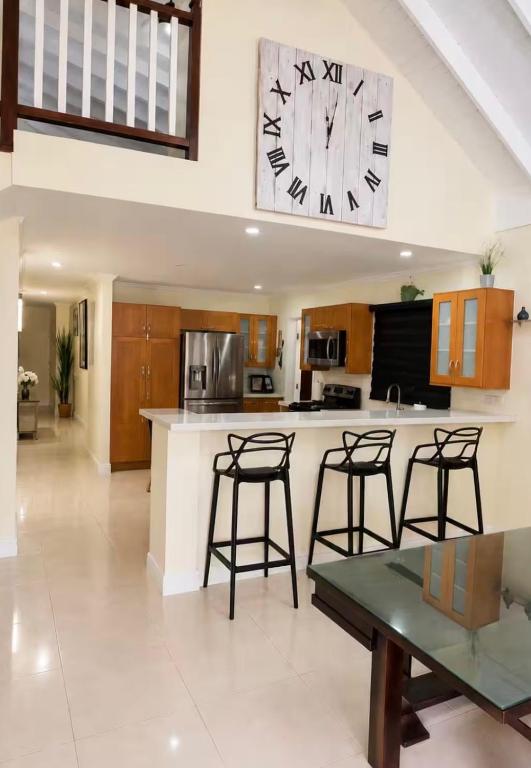 a large kitchen with a large clock on the wall at Apartment in St Ann in Priory