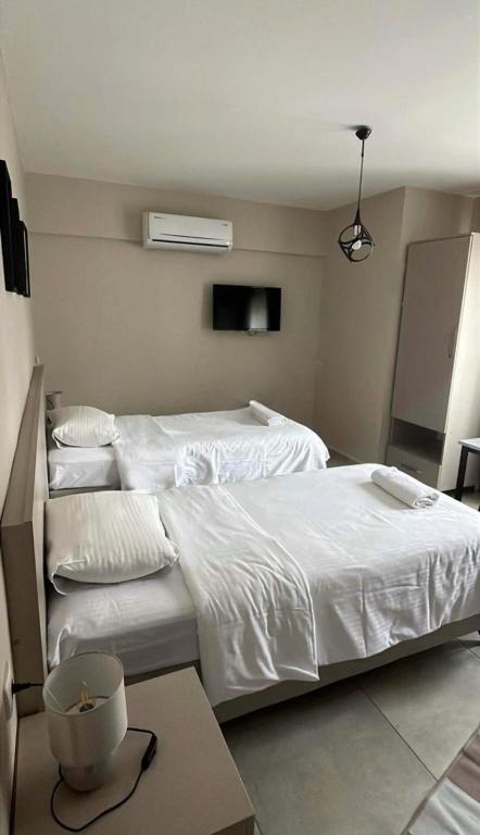 a bedroom with two beds with white sheets at Rain Suite in Istanbul