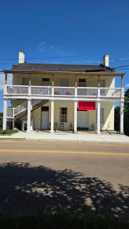 a large white building with a balcony on a street at Catherine's Palace in Vicksburg