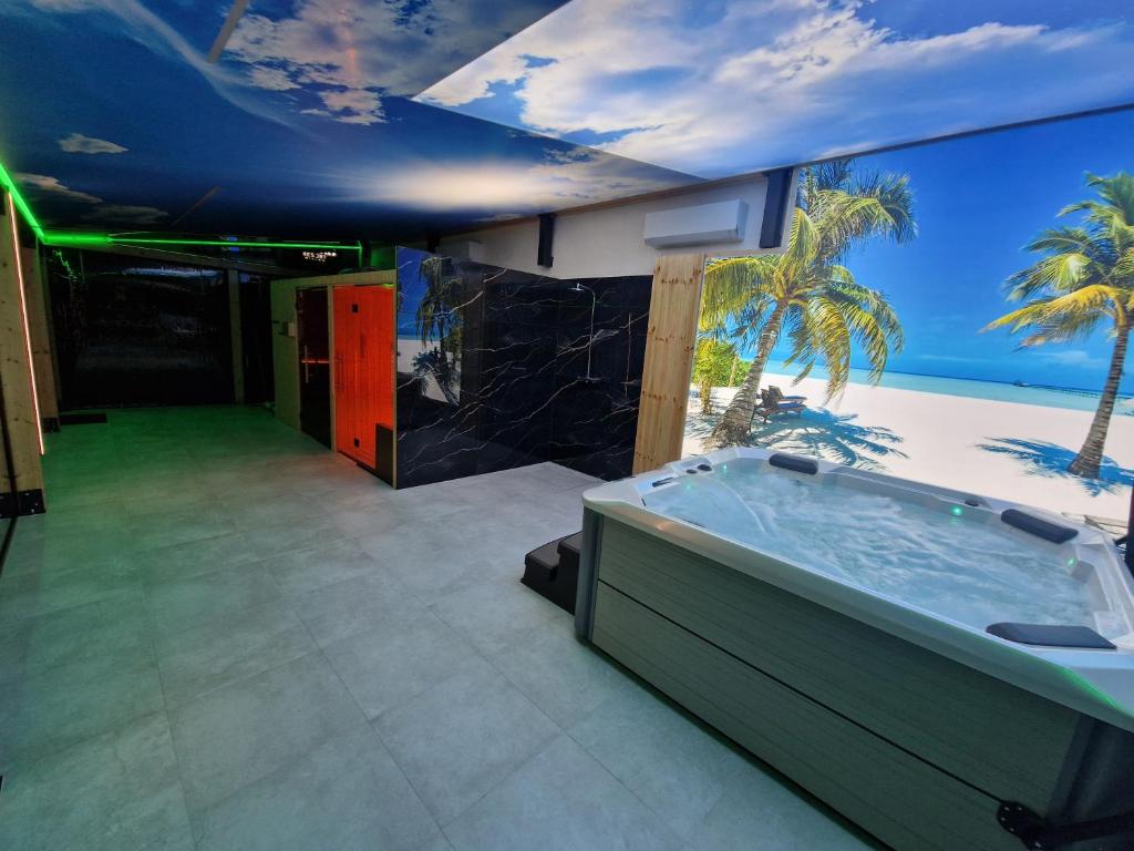 a bathroom with a tub with a view of the ocean at VILLA DORA - CENTRUM,BASEN PODGRZEWANY,JACUZZI SAUNA, Plac zabaw, Parking in Mielno
