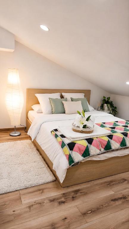 a bedroom with a large bed with a table on it at OsiedLOVE Poddasze in Jędrzejów