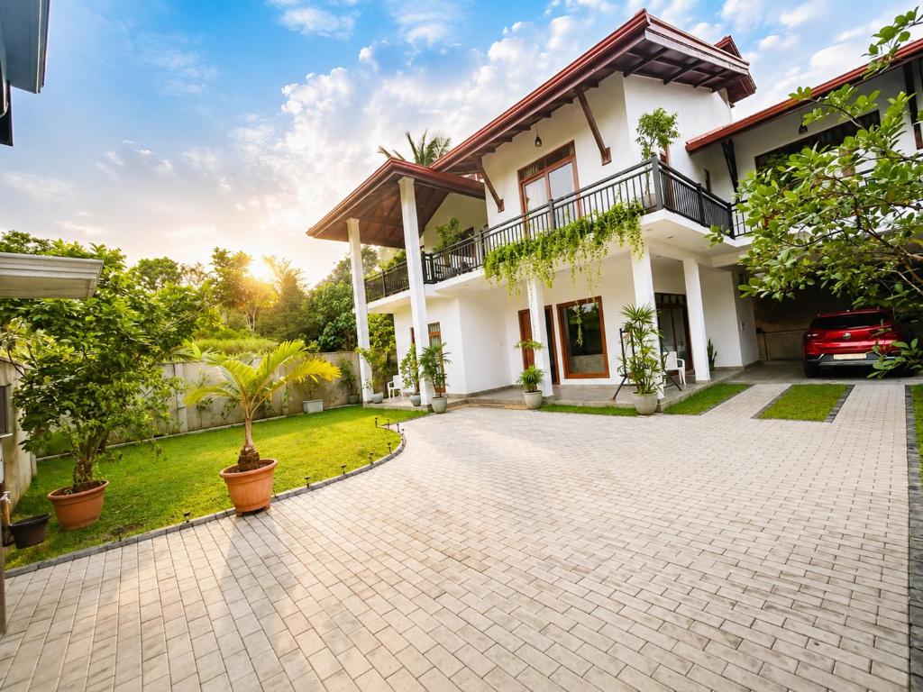 a house with a driveway in front of it at The Oak Residence in Ragama