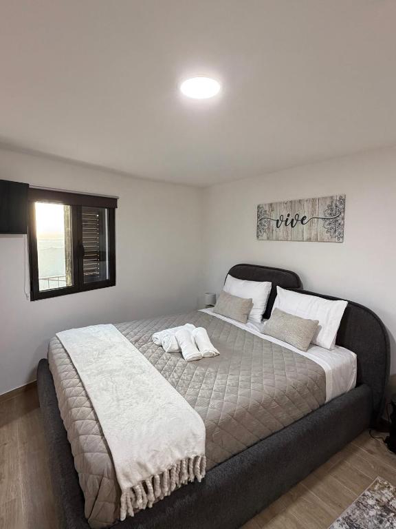 a bedroom with a large bed and a window at Casa dos Avós da Lapa in Lapa dos Dinheiros